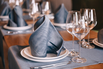 beautifully set tables with glasses, wine glasses and cutlery in the morning in a restaurant