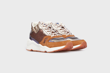 Varicoloured glossy leather high soled women's fashion sneakers, sports shoes, boots for female in isolated on white background. Shimmering footwear, training basketball shoes. Side view