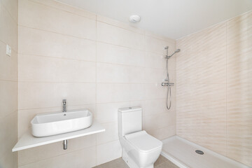 Fototapeta na wymiar Modern bathroom in white beige tones tile with vanity sink and an open shower in hotel or new apartment. Concept of stylish bathroom interiors with natural light
