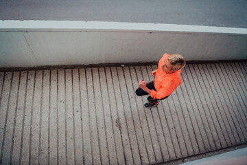Women in sports clothes running in a modern urban environment et night time. The concept of a...