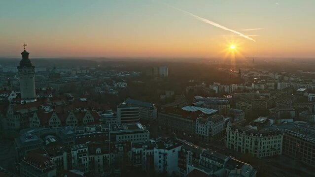 Drone shot revealing Leipzig Town hall tower (Rathausturm) at sunset
