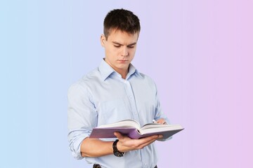Smart young man student reading book