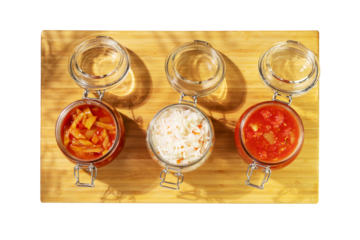 Probiotic food. Lecho, sauerkraut, ajvar in glass jars on a wooden board on transparent background. Fermented food. Home food preserving or canning