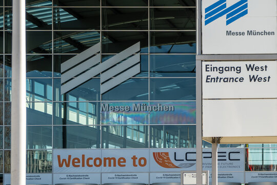 Entrance area of ​​Messe Munich with logo and Welcome to Lopec, a trade fair for congress and printed electronics Munich in sunshine, Munich, Bavaria, Germany
