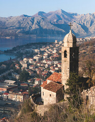 Fototapeta premium Church of Our Lady of Remedy in Kotor, Montenegro, beautiful top panoramic view of Kotor city old medieval town seen from San Giovanni St. John Fortress, with Adriatic sea, bay of Kotor and mountains
