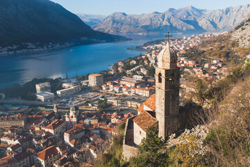 Fototapeta na wymiar Church of Our Lady of Remedy in Kotor, Montenegro, beautiful top panoramic view of Kotor city old medieval town seen from San Giovanni St. John Fortress, with Adriatic sea, bay of Kotor and mountains