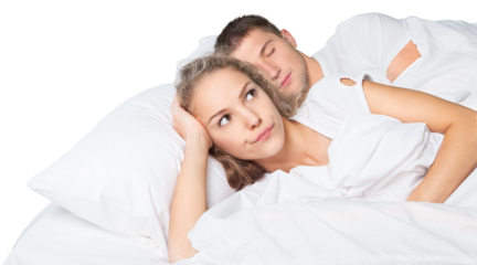 Happy young couple lying in bed