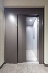 Elevator in a hall with closed, open and semi-closed doors