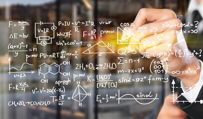 Young business person with equation on background