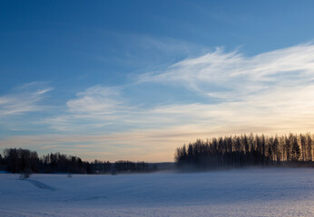 Fototapeta na wymiar Wintry landscape wallpaper image from Finland on a cold winter day.