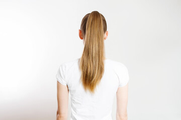 Closeup woman ponytail back view isolated on white background. Hair Natural blonde straight long Hairstyle. Easy quick simple making styling. Hair-extensions for beautiful pony tail. Copy space - obrazy, fototapety, plakaty