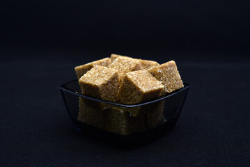 Pieces of cane sugar in a bowl. Refined sugar. Sugar in chunks in a cup.