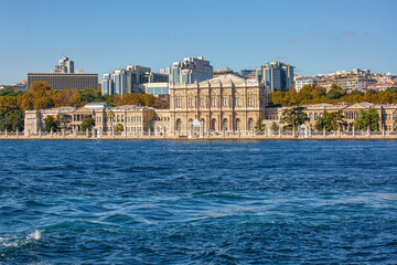 View to the shore of Bosforus strait on an early autumn day. Dolmabahce palace and residential buildings along the shore.