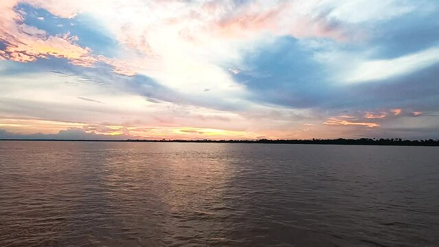 Time-lapse of sunset on the Amazon river from a boat.
