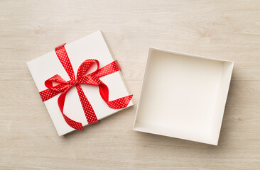 Open gift box on wooden background, top view