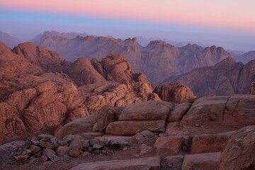 Beautiful sunrise view at Sinai mountain, Southern Egypt. Tourism concept. Natural wallpaper with blue sky abobe pink rocks.