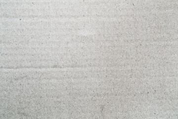 White grey color corrugated cardboard paper texture background with delicate stripes pattern. Vintage, old, soiled texture pattern background. 
