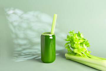 Greeb celery juice in a glass on a green background
