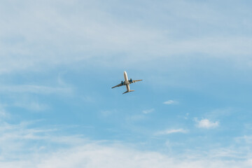 White passenger plane takes off in the sky, amazing clouds in the background. Travel by air