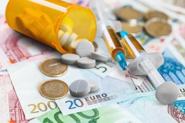 Medicine background with medical pills and money