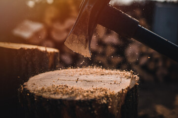 Man holding heavy ax. Axe in lumberjack hands chopping or cutting wood trunks .