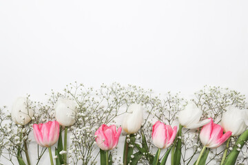 Pink tulips and white gypsophila flowers bouquet on a white background. Mothers Day, birthday...
