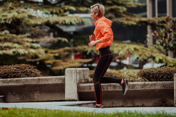  A blonde in a sports outfit is running around the city in an urban environment. The hot blonde maintains a healthy lifestyle.