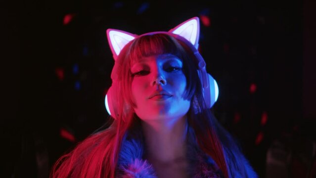 Sexy Gamer Girl Wearing Makeup And Headphones With Cat Ears In Neon Lighting