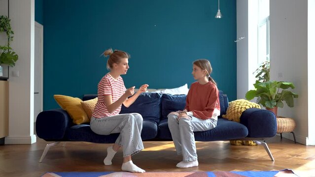 Upset teen girl make excuses justifies herself to dissatisfied mom. Frustrated mother scolding daughter at home. Quarrel between parents and children due to misunderstanding. Family conflict puberty.