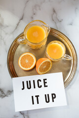 Juice it up sign with orange juice
