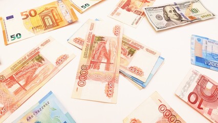 Top view of aa multi-currency. Euro, dollar, ruble banknotes isolated on white background.Cash. The concept of financial literacy and savers. stack of ruble surrounded by euros and rubles
