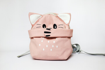 a cute pink backpack with a kitty paw closes its mouth. bullying at school