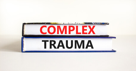 Complex trauma symbol. Concept words Complex trauma on books. Beautiful white table white...