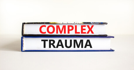 Complex trauma symbol. Concept words Complex trauma on books. Beautiful white table white background. Business psychology complex trauma concept. Copy space.