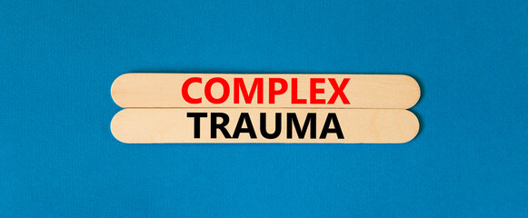 Complex trauma symbol. Concept words Complex trauma on wooden sticks. Beautiful blue table blue...