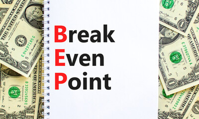 BEP break even point symbol. Concept words BEP break even point on white note on a beautiful background from dollar bills. Business and BEP break even point concept. Copy space.