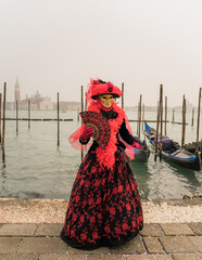 People wearing colorful and elaborate costumes during the Venice carnival in Italy 
