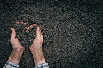 Handful of dirt hands heart shape. Agriculture symbol heart earth day. Male hands full of soil earth save environment day. Farmer hands soil ground earth dirt garden soil farm ground. Fertile ground