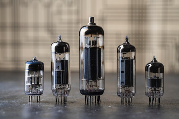 Old diode lamps of different sizes on a table, closeup. Several different vacuum tubes for old radio and TV