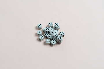 some dice game cubes with black dots on the color surface