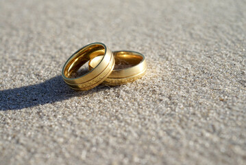 Wedding rings at the beach with copy space