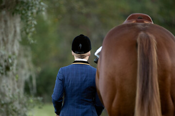 Classic English equestrian walking with horse. 