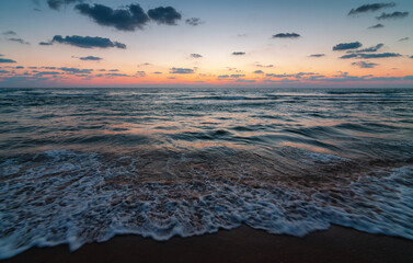 Obraz premium Sunset over the sandy beach of Mediterranean sea in Israel