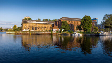 Fototapeta na wymiar Reflection of the old buildingin the lake with a azure sky