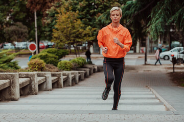  A blonde in a sports outfit is running around the city in an urban environment. The hot blonde maintains a healthy lifestyle.