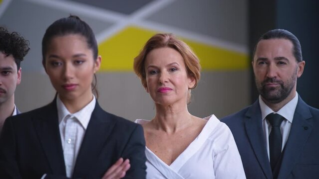 Colleagues, employees, workers in suits with documents looking at camera, professional team of specialists, camera moving from left to right