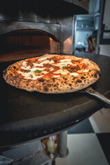 Pizza napoletana in preparation by pizzaiolo