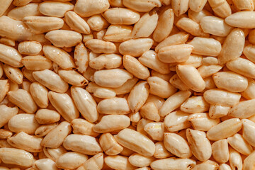 Air rice in dry sweet syrup, oval grains, background wallpaper, uniform texture pattern