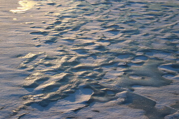 Ice growths on the river covered with snow, icy background