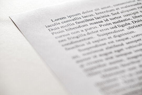 Lorem Ipsum text on printed on paper, sample of document, side view, selective focus